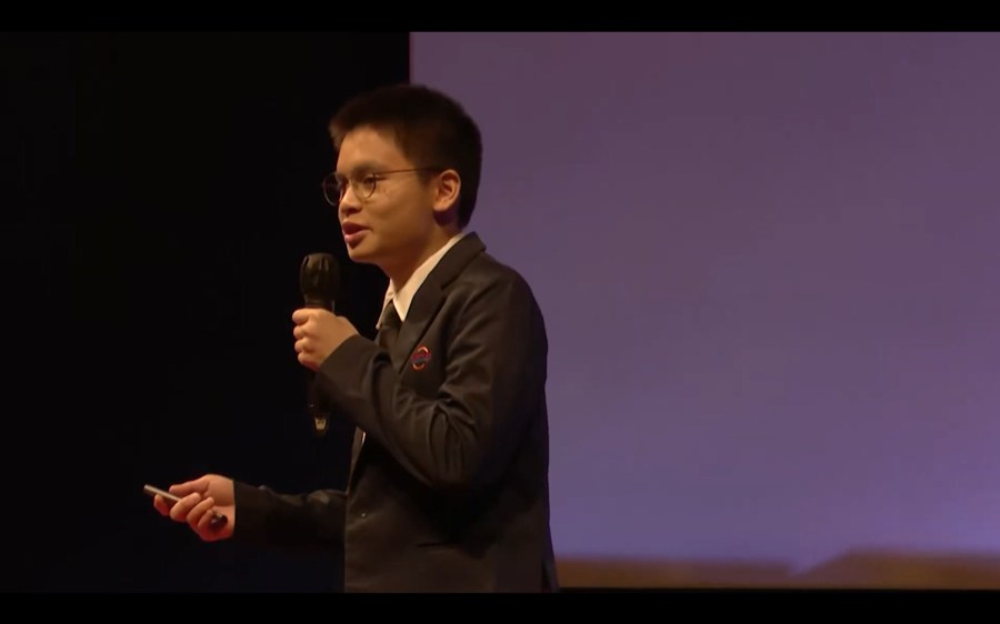 Joshua speaking on the TEDx stage